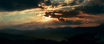 Movie still from “Transporter 3” (2008), directed by Olivier Megaton – The sun is setting over a mountain range; Extreme Wide shot, Low angle