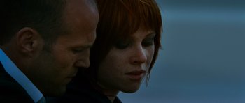 Movie still from “Transporter 3” (2008), directed by Olivier Megaton – A person's face with a man standing next to it; Extreme Close Up shot, Low angle