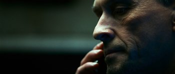 Movie still from “Transporter 3” (2008), directed by Olivier Megaton – A man's face while holding his hand to his face; Extreme Close Up shot, Low angle
