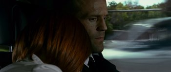 Movie still from “Transporter 3” (2008), directed by Olivier Megaton – A man and a woman in a car; Close Up shot, Over the shoulder angle