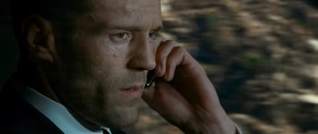 Movie still from “Transporter 3” (2008), directed by Olivier Megaton – A person talking on a cell phone; Close Up shot, Low angle