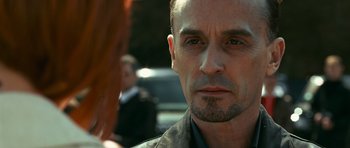 Movie still from “Transporter 3” (2008), directed by Olivier Megaton – A person with a beard; Close Up shot, Over the shoulder angle