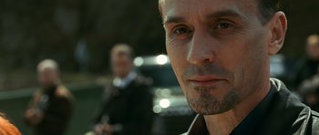 Movie still from “Transporter 3” (2008), directed by Olivier Megaton – A man's face with another man in the background; Close Up shot, Over the shoulder angle