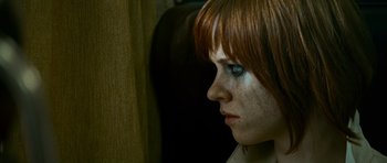 Movie still from “Transporter 3” (2008), directed by Olivier Megaton – A person with red hair and blue eyes; Close Up shot, Low angle