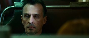 Movie still from “Transporter 3” (2008), directed by Olivier Megaton – A person sitting in front of a window; Close Up shot, Low angle