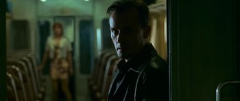 Movie still from “Transporter 3” (2008), directed by Olivier Megaton – A man standing in front of a train window; Close Up shot, Low angle