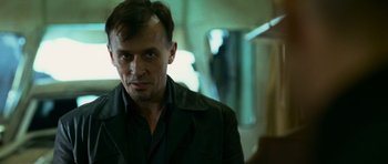 Movie still from “Transporter 3” (2008), directed by Olivier Megaton – A person wearing a jacket; Close Up shot, Low angle