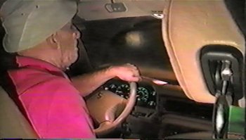 Movie still from “Trash Humpers” (2009), directed by Harmony Korine – An older man driving a car in the dark; Close Up shot, High angle