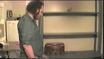 Movie still from “Trash Humpers” (2009), directed by Harmony Korine – A man standing in front of an old radio; Medium shot, Over the shoulder angle