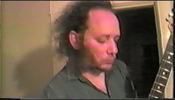 Movie still from “Trash Humpers” (2009), directed by Harmony Korine – A man with long hair and a beard is looking at the camera; Close Up shot, High angle