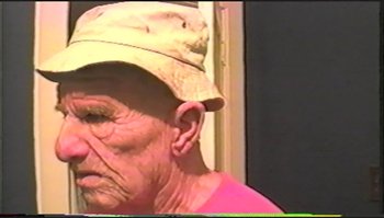 Movie still from “Trash Humpers” (2009), directed by Harmony Korine – An old man wearing a hat looking at the camera; Close Up shot, High angle