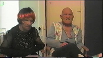 Movie still from “Trash Humpers” (2009), directed by Harmony Korine – A man and a woman sitting next to each other in a room; Close Up shot, High angle