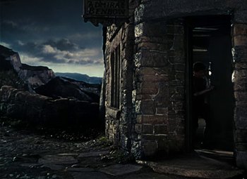 Movie still from “Treasure Island” (1950), directed by Byron Haskin – A building that has a sign on the side of it; Extreme Wide shot, High angle