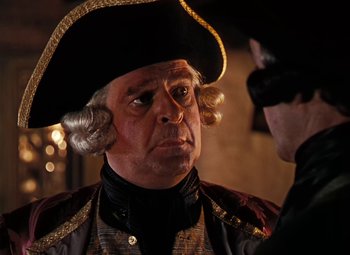 Movie still from “Treasure Island” (1950), directed by Byron Haskin – A man in a pirate costume and a man in a black hat; Close Up shot, Over the shoulder angle