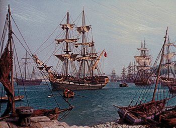 Movie still from “Treasure Island” (1950), directed by Byron Haskin – A group of ships in the water near the shore; Extreme Wide shot, High angle