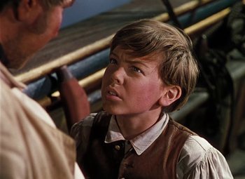 Movie still from “Treasure Island” (1950), directed by Byron Haskin – A young boy is looking at a man; Close Up shot, Over the shoulder angle