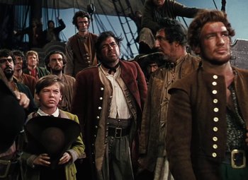 Movie still from “Treasure Island” (1950), directed by Byron Haskin – A group of people standing on top of a boat; Medium shot, High angle
