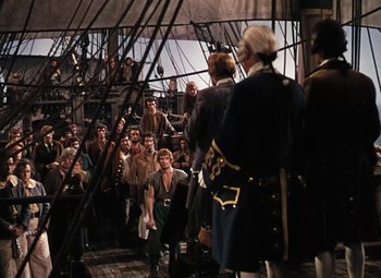 Movie still from “Treasure Island” (1950), directed by Byron Haskin – A group of people standing on top of a boat; Wide shot, High angle