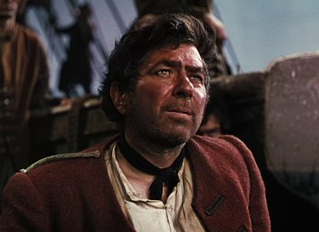 Movie still from “Treasure Island” (1950), directed by Byron Haskin – A man in a red jacket looking up at the sky; Close Up shot, Low angle