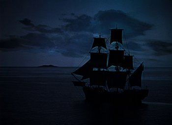 Movie still from “Treasure Island” (1950), directed by Byron Haskin – A boat in the middle of the ocean at night; Extreme Wide shot, Low angle