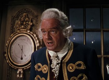Movie still from “Treasure Island” (1950), directed by Byron Haskin – An older man in a suit and a clock; Close Up shot, High angle