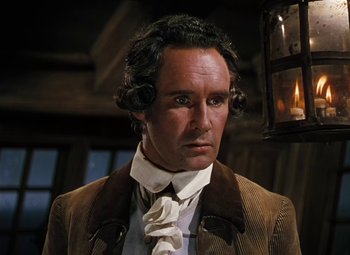 Movie still from “Treasure Island” (1950), directed by Byron Haskin – A person wearing a suit and tie; Close Up shot, Low angle