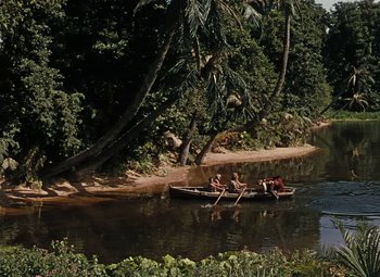 Movie still from “Treasure Island” (1950), directed by Byron Haskin – A group of people in a boat on a body of water; Extreme Wide shot, High angle