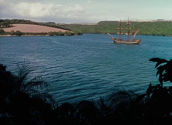 Movie still from “Treasure Island” (1950), directed by Byron Haskin – A boat in the middle of the water; Extreme Wide shot, High angle