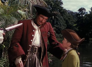 Movie still from “Treasure Island” (1950), directed by Byron Haskin – A man and a boy in a pirate costume; Medium shot, Over the shoulder angle