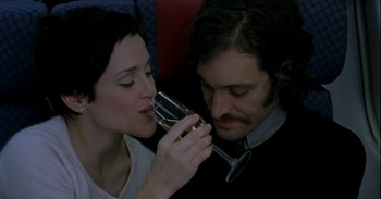 Movie still from “Trouble Every Day” (2001), directed by Claire Denis – A man and a woman are drinking wine together; Close Up shot, High angle