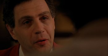 Movie still from “Trouble Every Day” (2001), directed by Claire Denis – A man's face in a dark room; Close Up shot, Over the shoulder angle