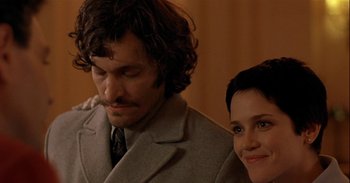 Movie still from “Trouble Every Day” (2001), directed by Claire Denis – A man and a woman sitting next to each other in a room; Close Up shot, Over the shoulder angle