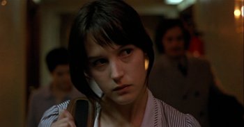 Movie still from “Trouble Every Day” (2001), directed by Claire Denis – A woman holding a cell phone in her hand; Close Up shot, Low angle