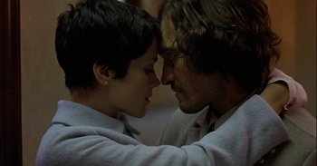 Movie still from “Trouble Every Day” (2001), directed by Claire Denis – A man and a woman face to face in front of each other; Close Up shot, Low angle