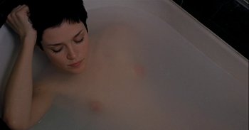 Movie still from “Trouble Every Day” (2001), directed by Claire Denis – A woman is in a bath tub with water on the floor; Close Up shot, Overhead angle