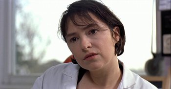 Movie still from “Trouble Every Day” (2001), directed by Claire Denis – A person wearing a white shirt; Close Up shot, Over the shoulder angle