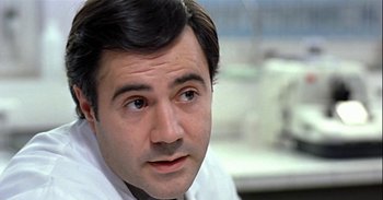 Movie still from “Trouble Every Day” (2001), directed by Claire Denis – A person wearing a lab coat; Close Up shot, Low angle