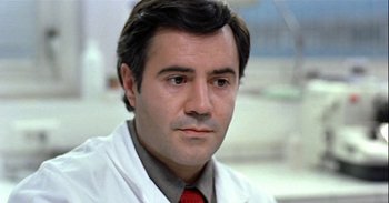 Movie still from “Trouble Every Day” (2001), directed by Claire Denis – A person wearing a white lab coat; Close Up shot, Low angle