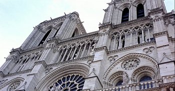 Movie still from “Trouble Every Day” (2001), directed by Claire Denis – A large building with many windows on the outside; Extreme Wide shot, Low angle