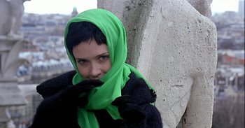 Movie still from “Trouble Every Day” (2001), directed by Claire Denis – A woman wearing a green head scarf and a black jacket; Close Up shot, High angle