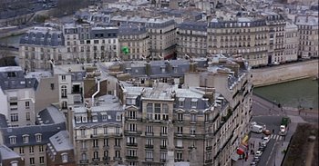 Movie still from “Trouble Every Day” (2001), directed by Claire Denis – A view of many buildings in a large city; Extreme Wide shot, High angle