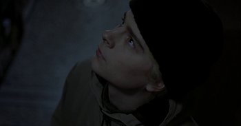 Movie still from “Trouble Every Day” (2001), directed by Claire Denis – A young man looking up into the dark sky; Close Up shot, Low angle