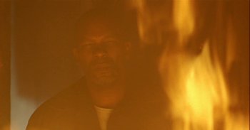 Movie still from “Trouble Every Day” (2001), directed by Claire Denis – A person with a fire in the background; Close Up shot, Low angle