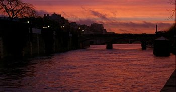 Movie still from “Trouble Every Day” (2001), directed by Claire Denis – A view of a bridge and a body of water at sunset; Extreme Wide shot, Low angle