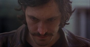 Movie still from “Trouble Every Day” (2001), directed by Claire Denis – A person with a mustache; Close Up shot, High angle