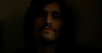 Movie still from “Trouble Every Day” (2001), directed by Claire Denis – A person with a mustache; Close Up shot, Low angle