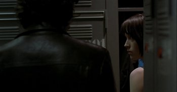 Movie still from “Trouble Every Day” (2001), directed by Claire Denis – A man and a woman standing next to each other in a room; Close Up shot, Over the shoulder angle