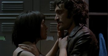 Movie still from “Trouble Every Day” (2001), directed by Claire Denis – A man and a woman touching their noses; Close Up shot, Low angle