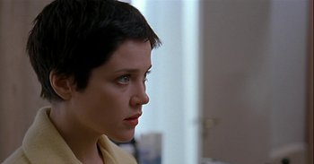 Movie still from “Trouble Every Day” (2001), directed by Claire Denis – A person with short black hair; Close Up shot, Over the shoulder angle
