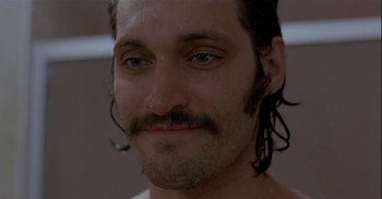 Movie still from “Trouble Every Day” (2001), directed by Claire Denis – A person with a mustache; Close Up shot, Low angle